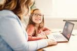 Mother and daughter on a laptop at home