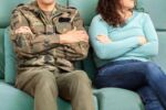 Cropped shot of a soldier and his unrecognizable wife sitting on the couch with their arms crossed Visual concept for a blog discussing Military Divorce.